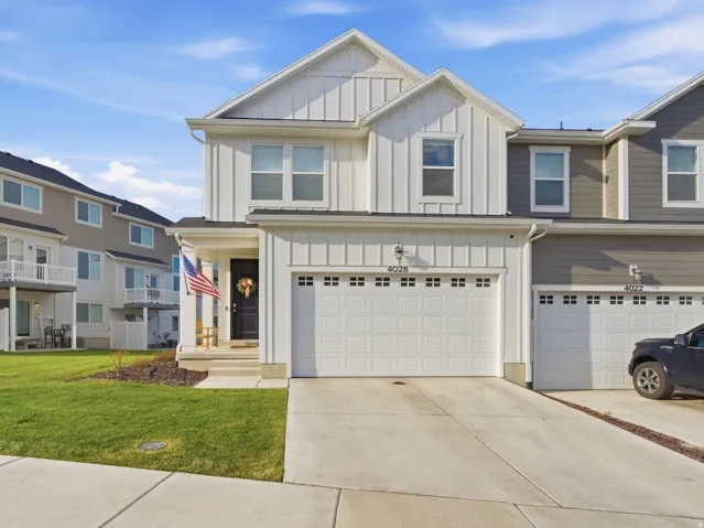 Two-story facade with vertical and horizontal siding, attached garage 2 Car garage, and concrete driveway