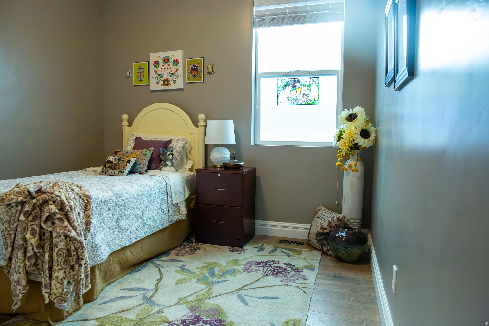 Neutral wall tones complement the wood-finish flooring