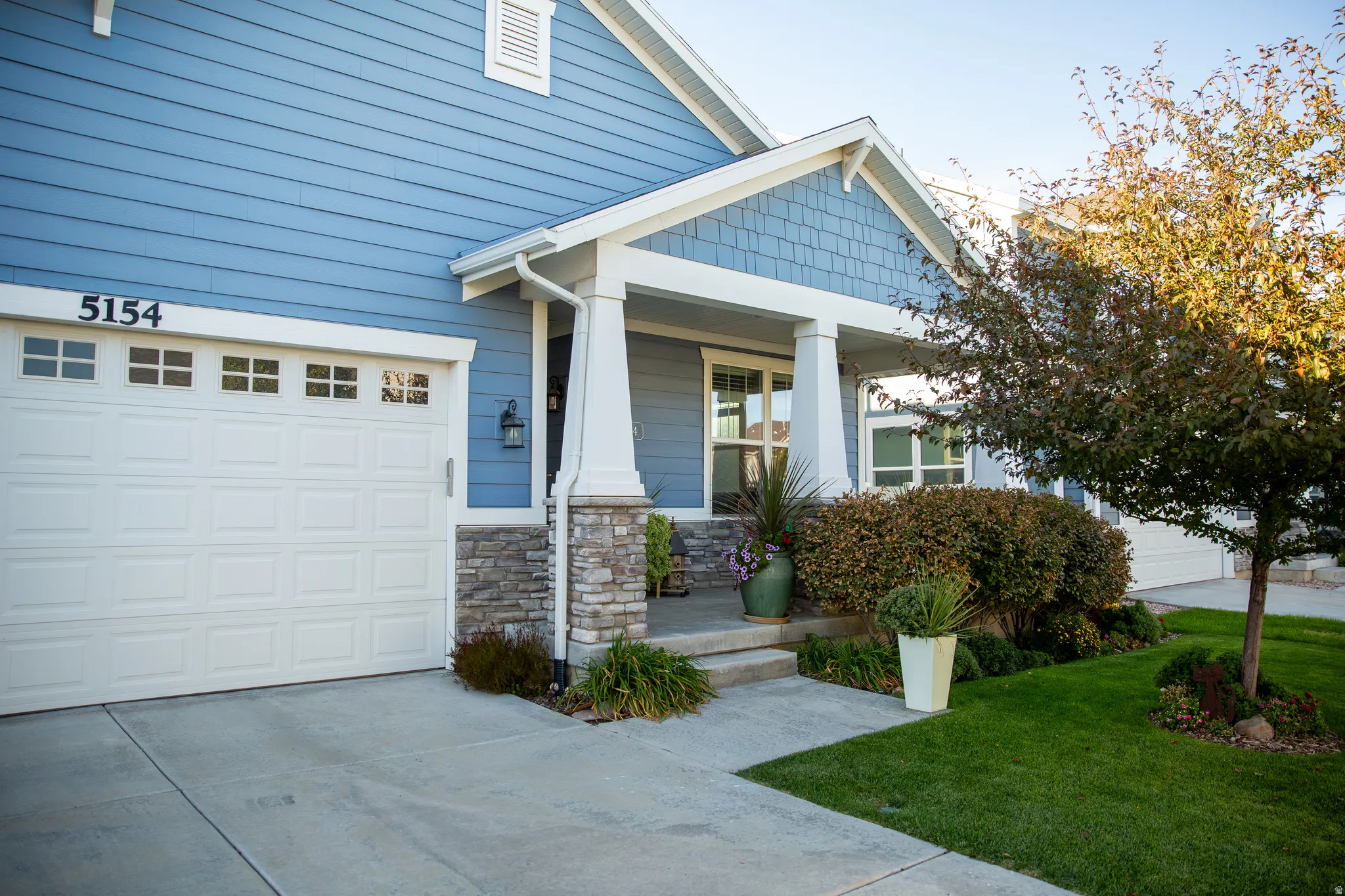 Blue siding exterior with stone accent columns