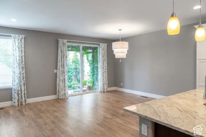 Wood-finish flooring with a multi-tiered chandelier