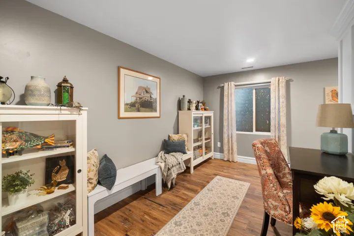 Wood-finish flooring, light gray wall paint, and white trim accents