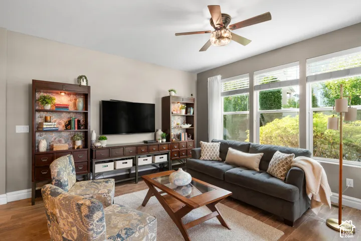 Recessed lighting, wood-finish flooring, ceiling fan with crystal accents, built-in shelving, and multiple large windows