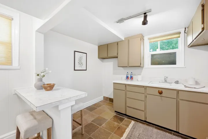 Built-in countertop with an integrated sink and track lighting