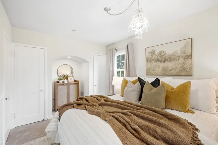 Archway alcove with recessed lighting, white solid core doors, and a decorative chandelier