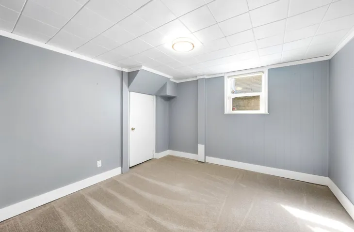 Light grey painted walls, white trim, and a window