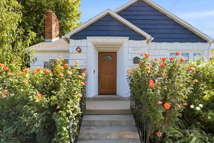 Wood-paneled entry door with an arched window