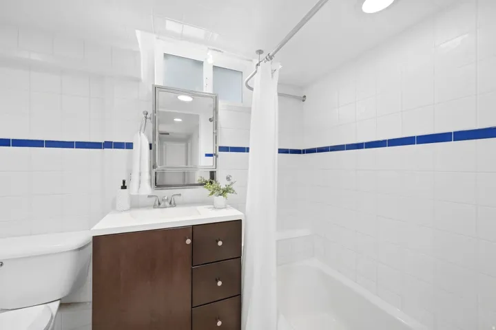 White tiled walls with a blue accent band
