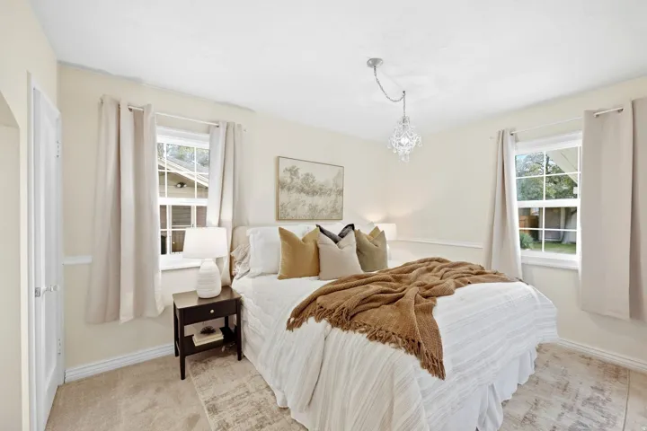 Recessed lighting, wood-finish flooring, and a crystal chandelier