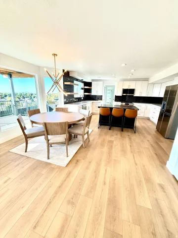 Open-concept kitchen and dining area with wood-finish flooring