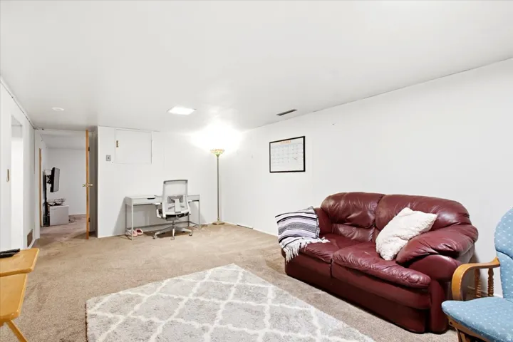 Carpeted flooring throughout, recessed ceiling lighting, and solid core interior doors