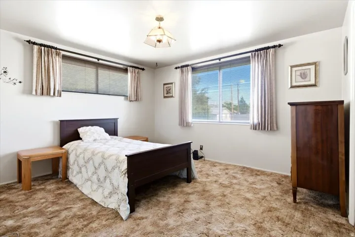 White walls featuring a large window, a smaller upper window, and a ceiling-mounted light fixture