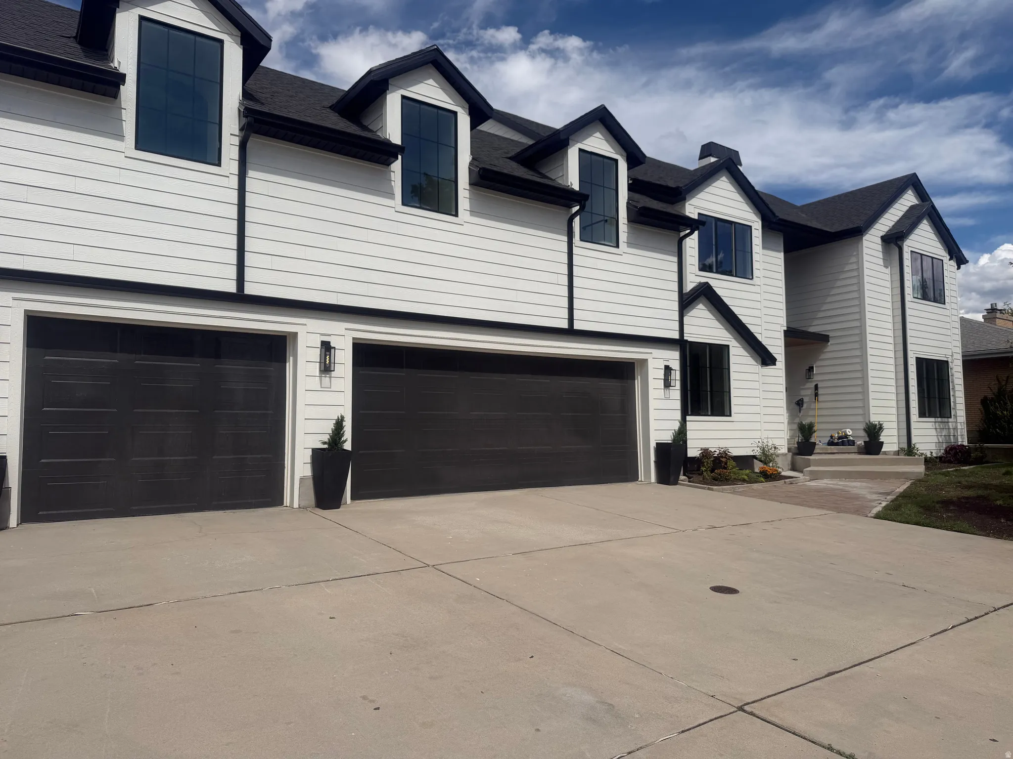 Contemporary exterior with white horizontal siding and black trim accents