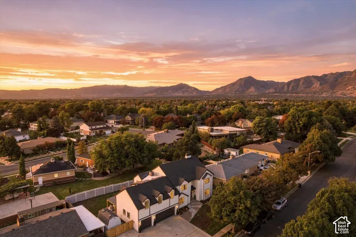 Mountainous backdrop framing a residential neighborhood with mature trees