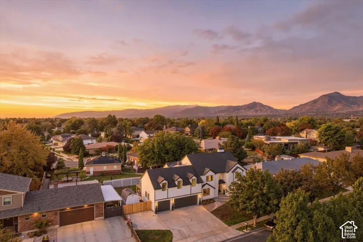 New construction residence featuring a two-car garage, dormer windows, and a paved driveway