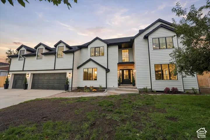 Modern farmhouse exterior with white horizontal siding and black trim accents