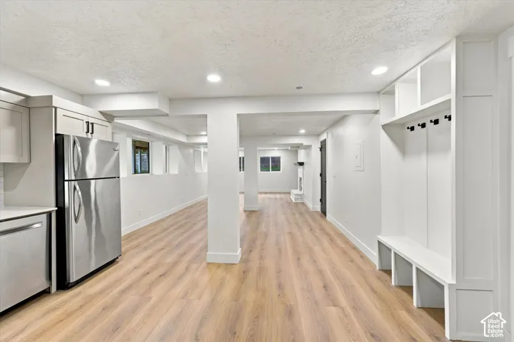 Recessed lighting, wood-finish flooring, built-in mudroom bench, built-in shelving, and stainless steel appliances