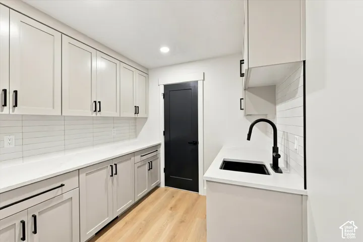 Light wood-finish flooring complements abundant light-toned cabinetry