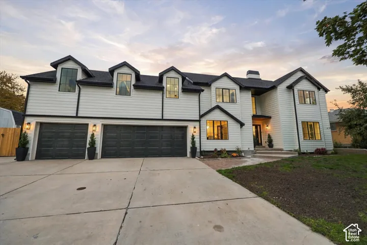 White horizontal siding exterior with black trim and a black shingle roof