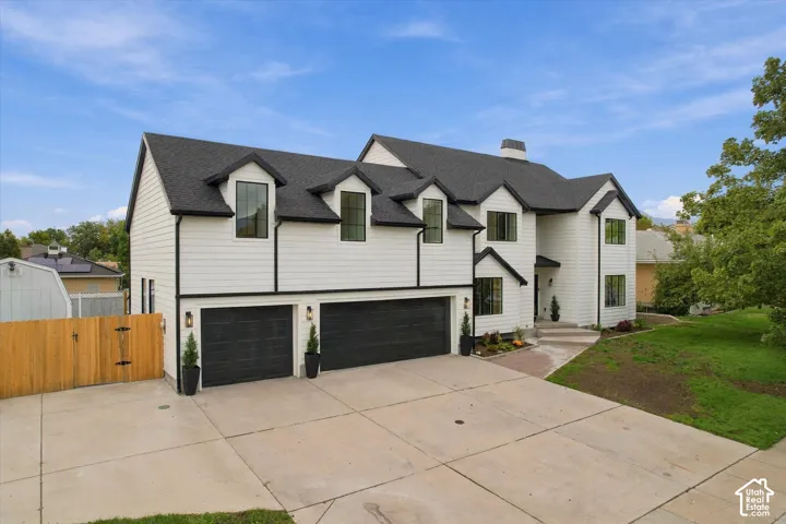 Modern two-story residence with white siding and black trim