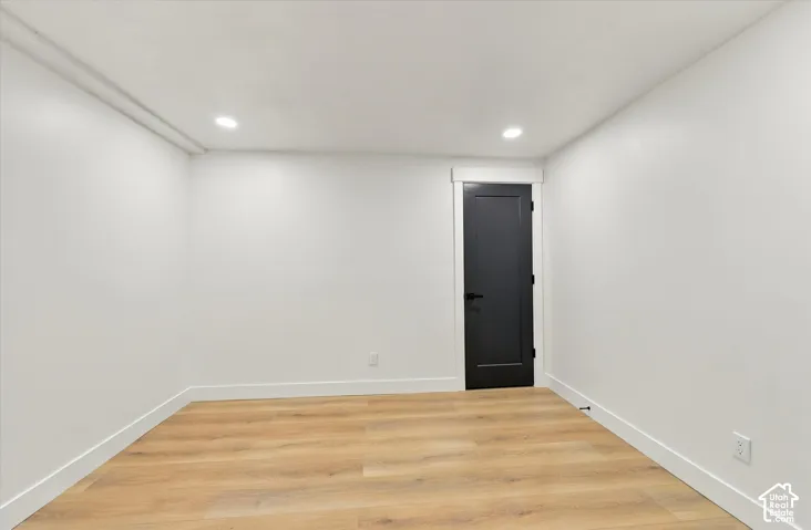 Wood-finish flooring with white baseboards