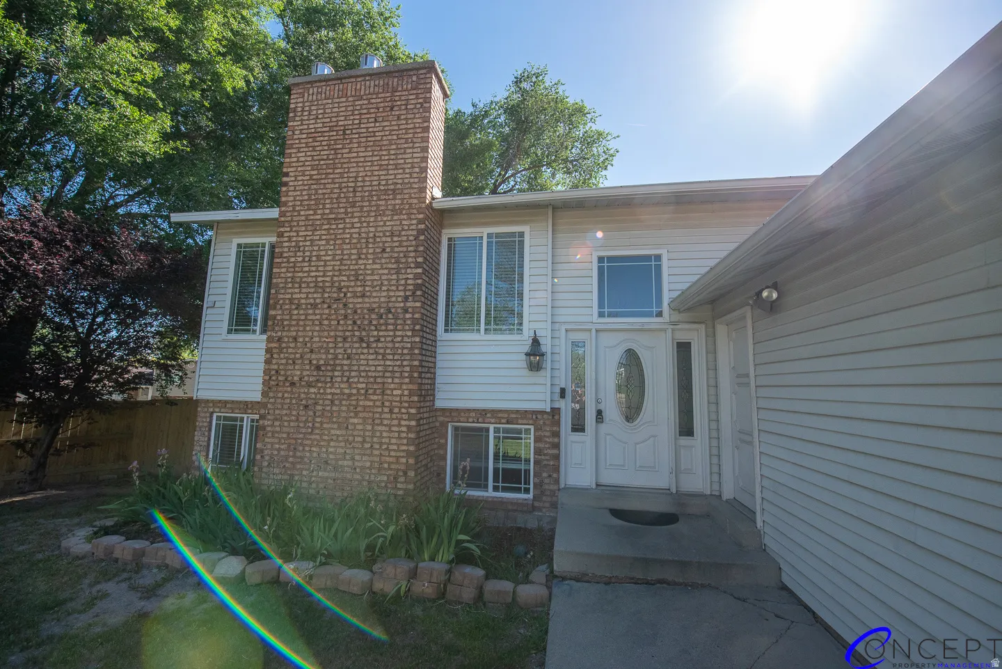 Brick and siding exterior with a prominent brick chimney