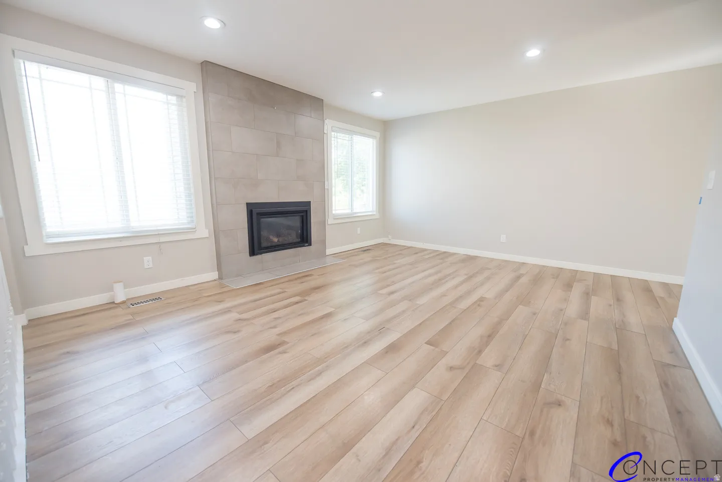 Recessed lighting illuminates the wood-finish flooring