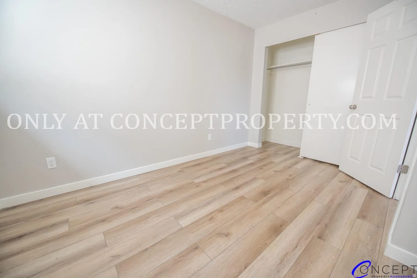 Wood-finish flooring, light-toned walls, and a built-in closet with sliding doors