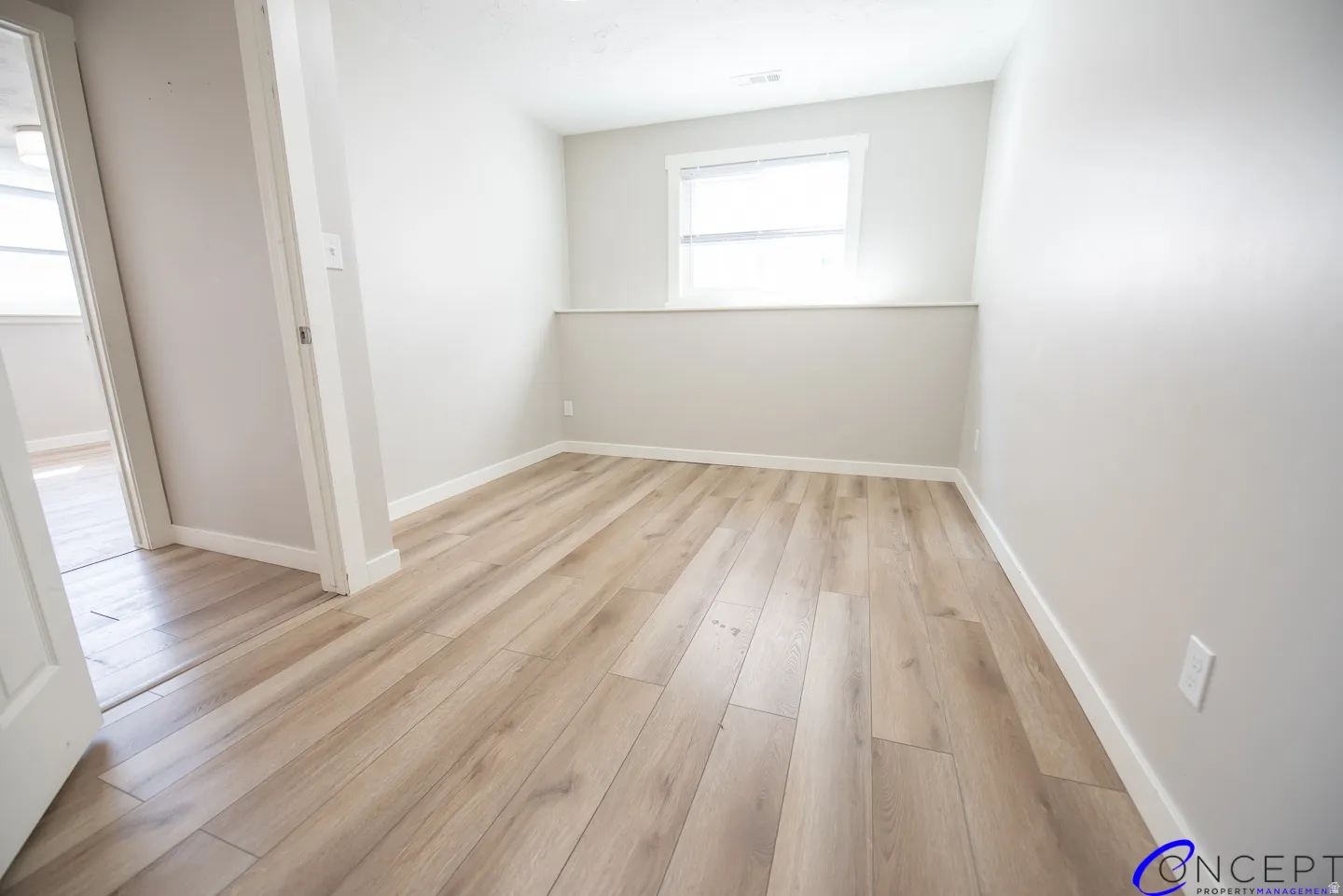 Wood-finish flooring throughout, neutral paint palette, and white trim