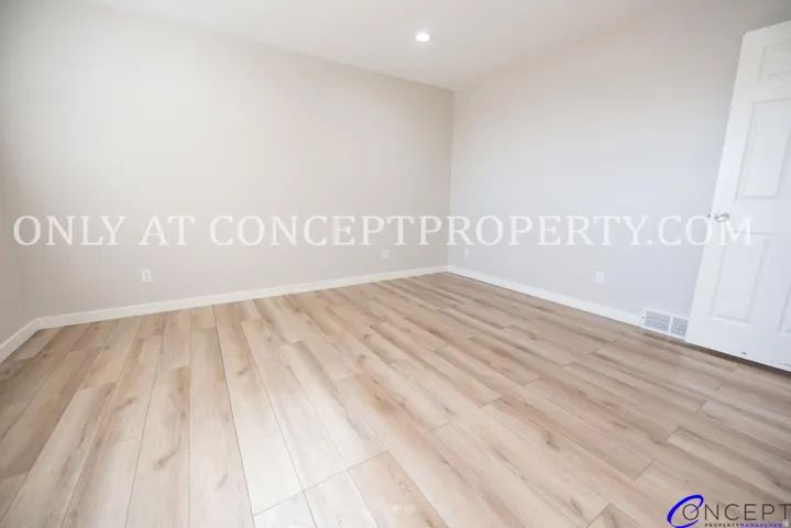 Wood-finish flooring with neutral wall tones and white trim