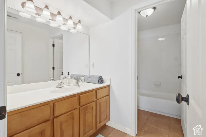 Basement hall bathroom with separate vanity and door for shower / toilet room