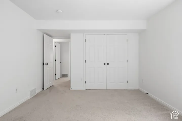 Light-colored carpeting, white interior walls, and white trim