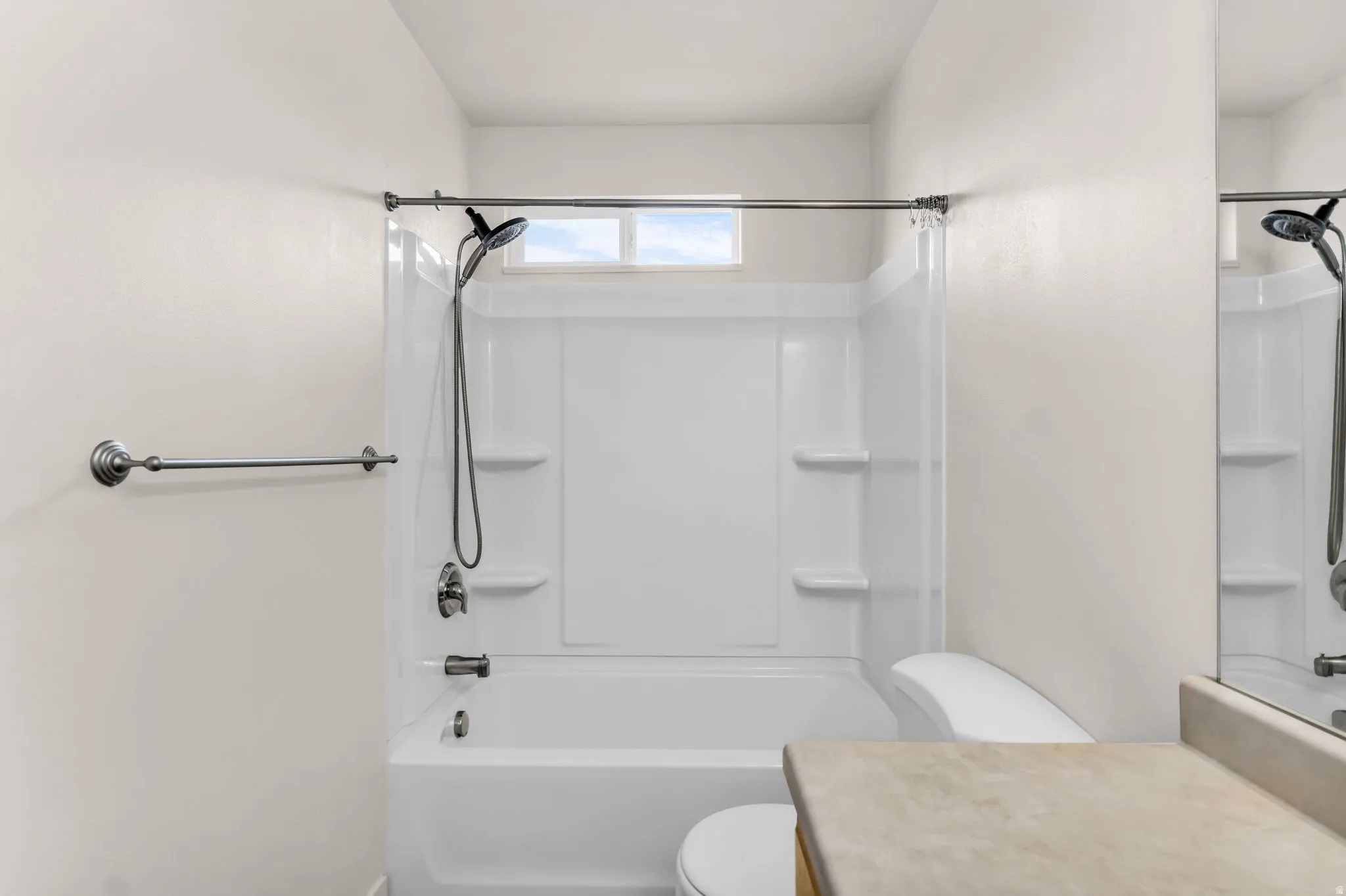 White acrylic tub and shower combination with an integrated window