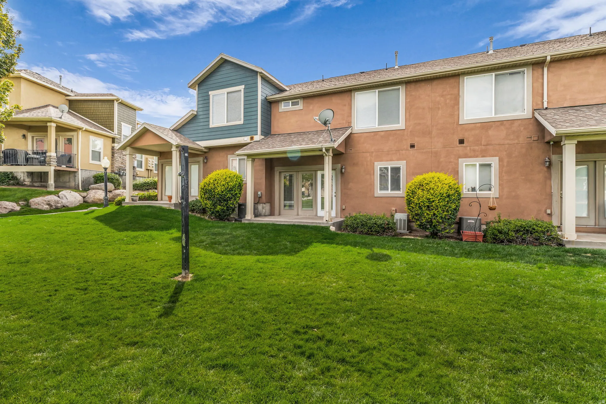 Expansive grass area with a covered patio and direct access to the interior