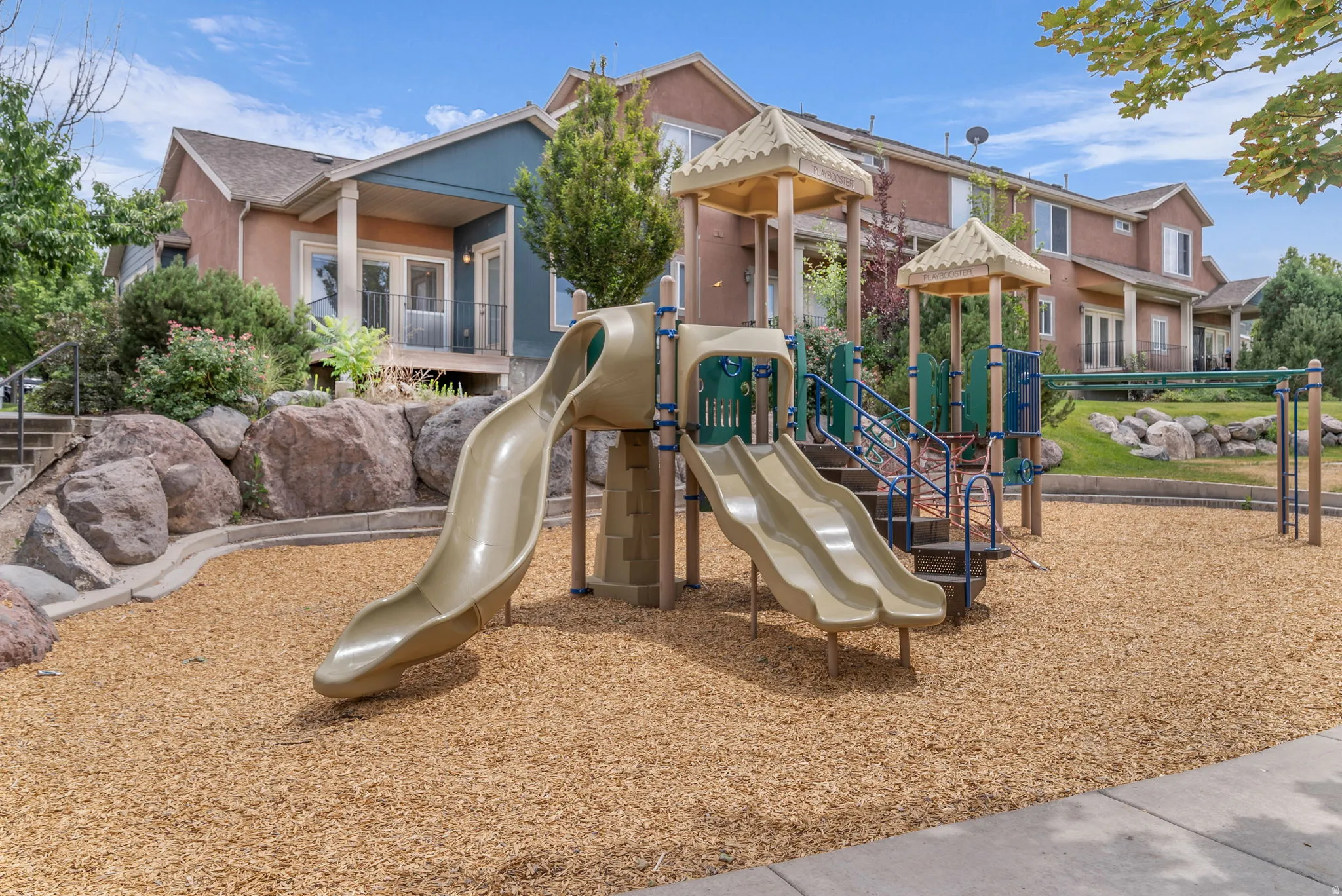Community playground featuring multiple slides and climbing structures