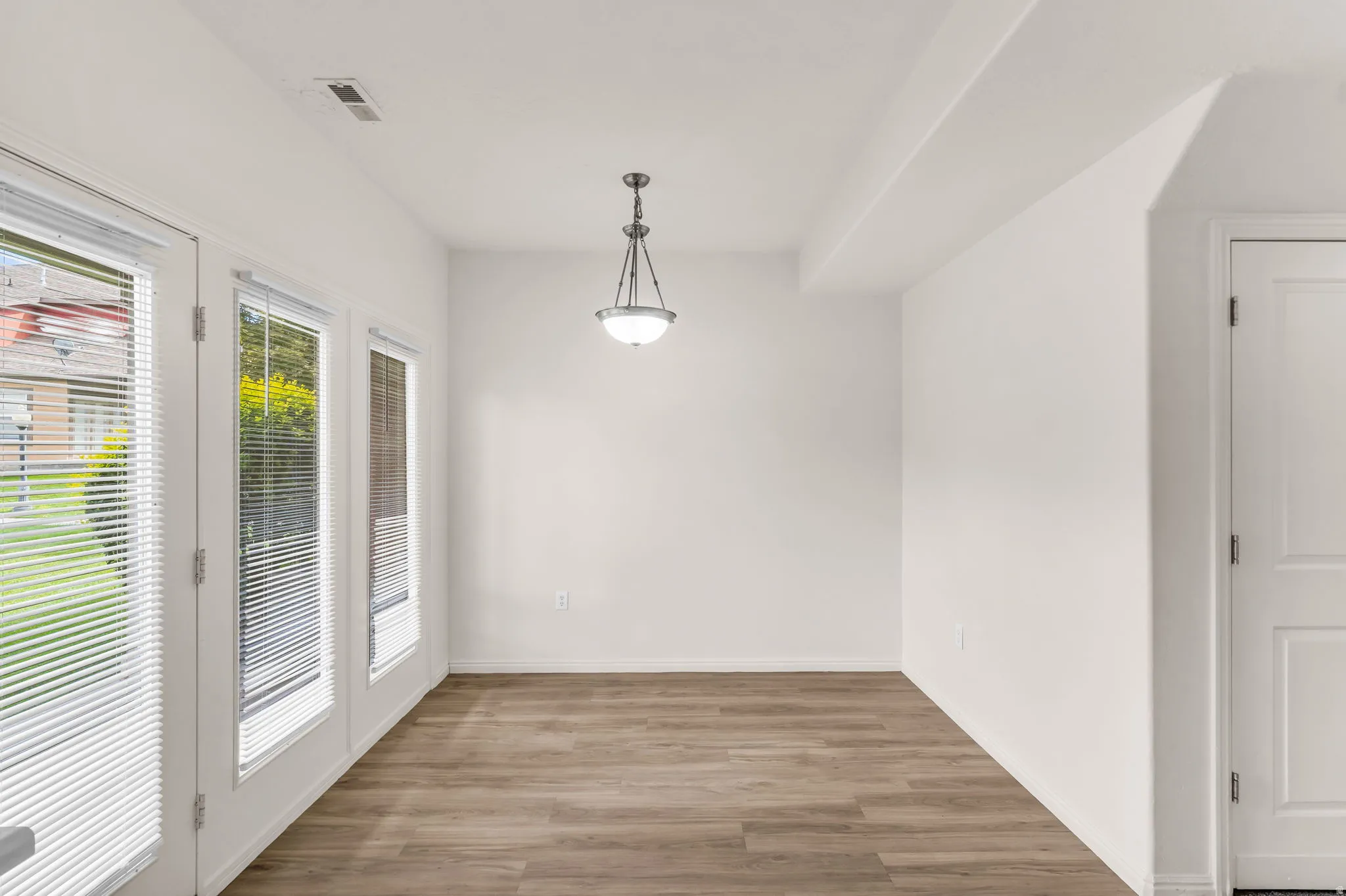Wood-finish flooring with white walls and trim