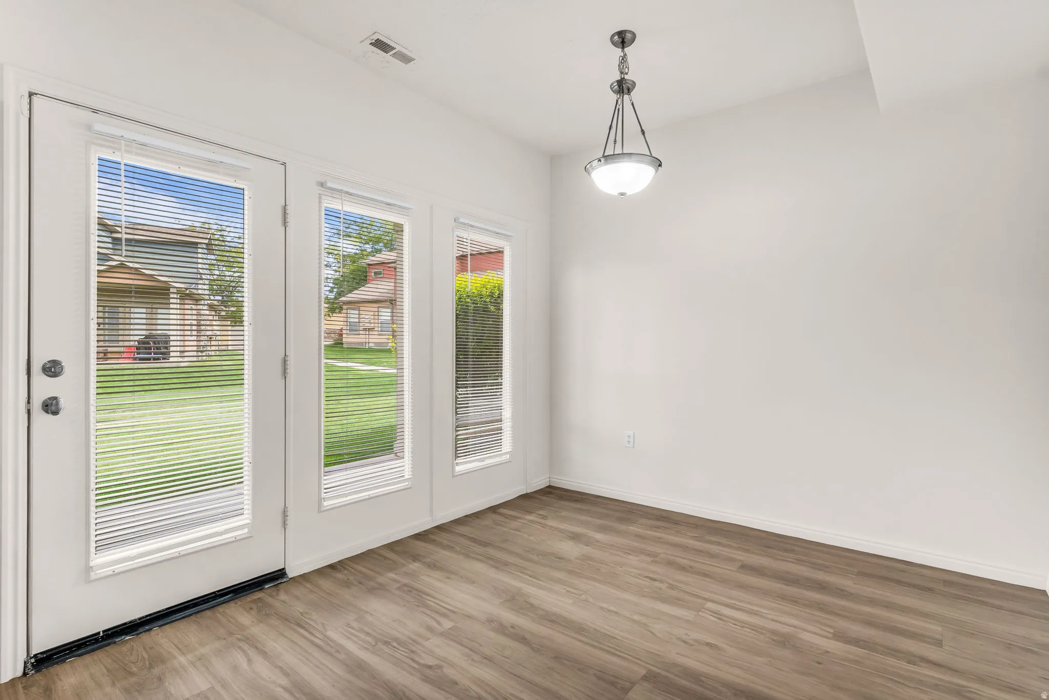 Wood-finish flooring with white baseboards