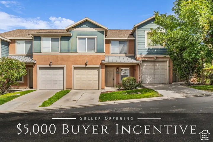 Multi-level exterior featuring stucco and horizontal siding, metal roofing accents, and three individual garage bays with private concrete driveways