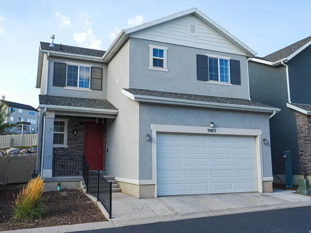 Stucco exterior with stone accents and a covered porch