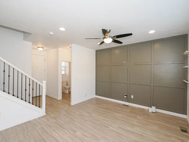 Wood-finish flooring, recessed lighting, and a contemporary ceiling fan
