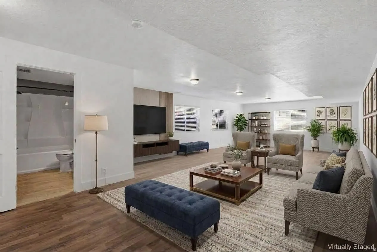 Wood-finish flooring throughout, recessed lighting, and multiple windows with blinds