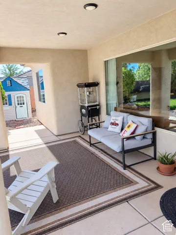 Covered patio with recessed lighting, stucco exterior, and large windows