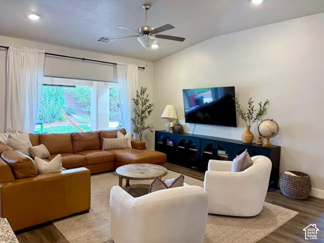 Vaulted ceiling with recessed lighting and a ceiling fan
