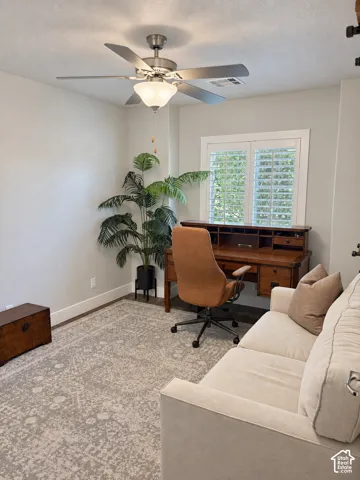 Recessed ceiling lighting, ceiling fan with integrated light fixture, wood-finish flooring, plantation shutters, and a built-in wooden desk