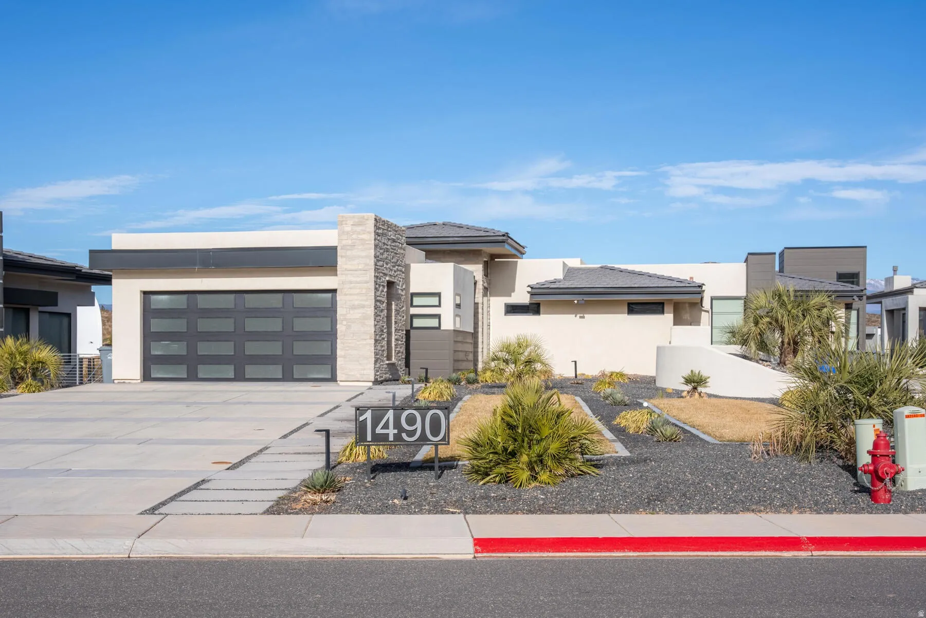 Contemporary architectural style with a stucco and stone facade