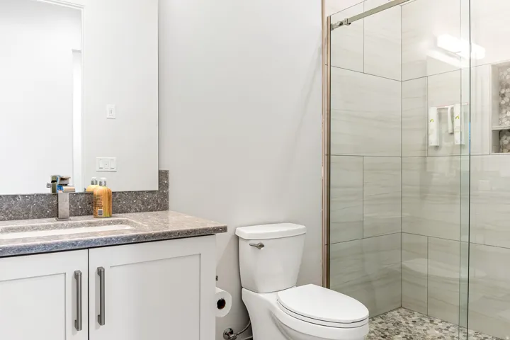Vanity with a speckled countertop, undermount sink, and chrome faucet
