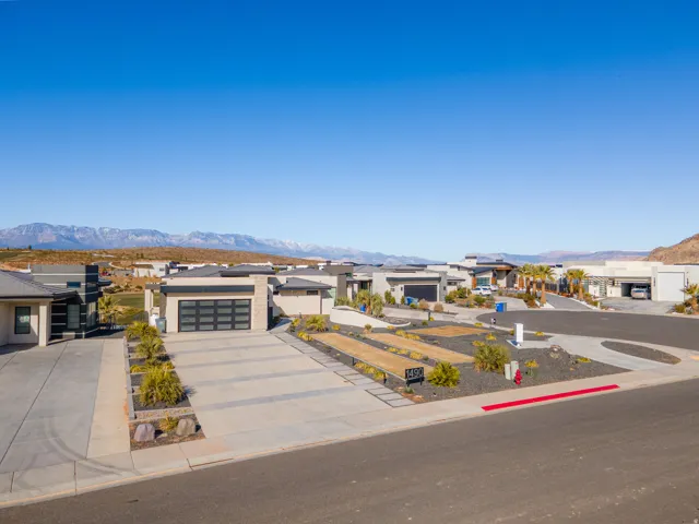 Modern residential architecture with flat roofs, expansive driveways, and low-maintenance landscaping