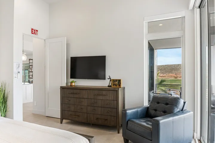 Sliding glass door leading to outdoor space, white walls, and light-toned flooring