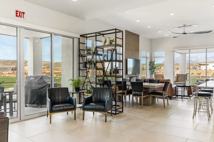 Spacious room featuring large format tile flooring, a modern ceiling fan, and extensive glass sliding doors