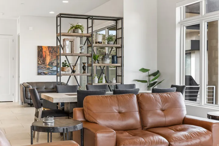 Recessed lighting, large windows, tile flooring, and a built-in shelving unit