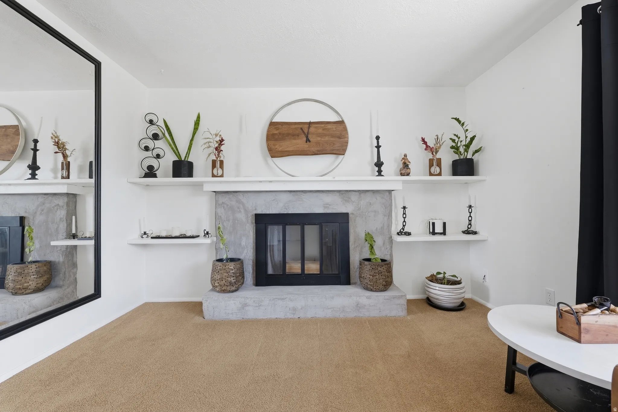Recessed fireplace with a hearth, mantel, and built-in shelving